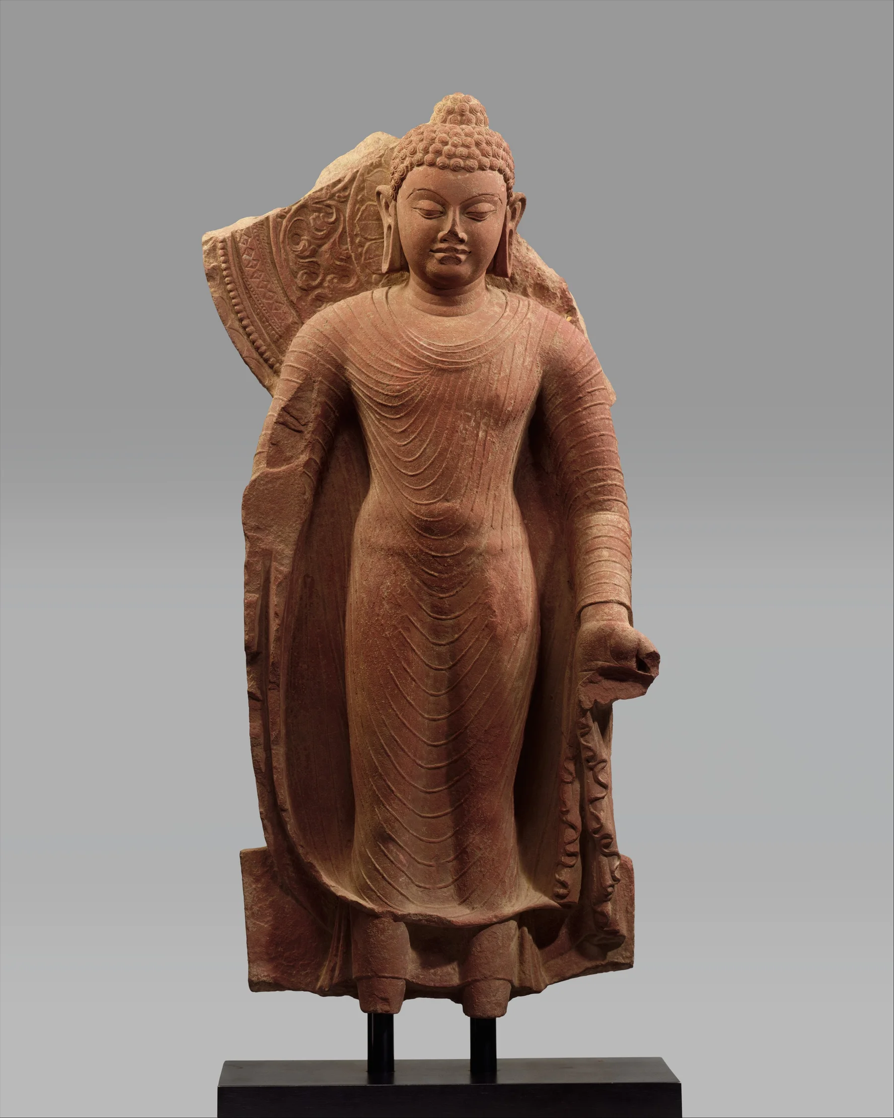Red sandstone standing Buddha offering protection, made in Mathura in the late fifth century.